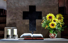 Close-up Of Flower Vase And Bible On Table