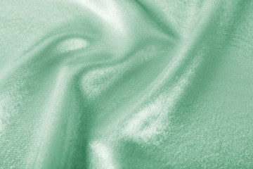 Texture of beautiful silk as background. Image toned in mint color