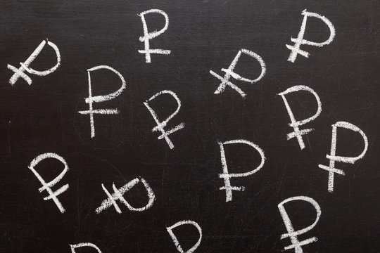 Symbol of the Russian currency Ruble on a chalk Board. Background