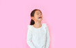 Portrait asian little child girl crying isolated on pink background with copy space. Kid with sad expressions.