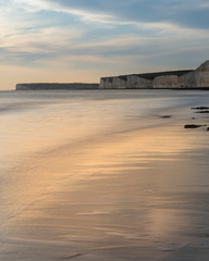 Wall Mural - Stunning landscape image of white chalk cliffs with colorful vibrant sunset on English coast