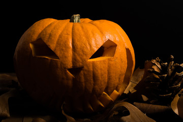 Scary and spooky hand carved Halloween pumpkin with flames inside