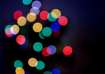 Blurred abstract pattern - color bokeh on black background