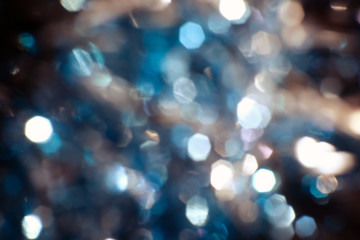 Wall Mural - Dark Abstract blue bokeh sparkle on black background