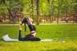 © ekaterina_devis - Young Caucasian woman doing yoga in the Park.