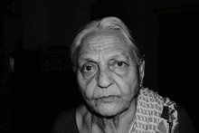 Portrait Of Senior Woman Against Black Background