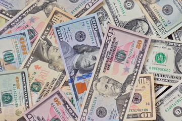 Wall Mural - Money american dollar bills Pile of various currencies isolated on white background.Closeup of assorted American banknotes.US currency scattered on the table.america currency dollor currency.