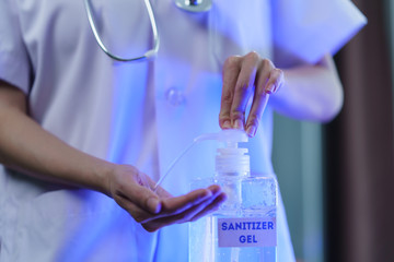 Doctor wash hand with disinfectant gel dispenser during the epidemic covid-19.