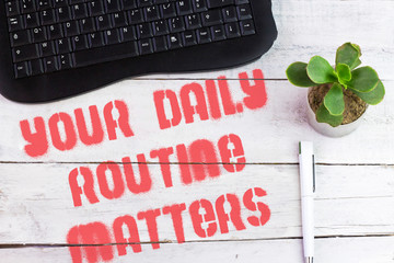 Wall Mural - Handwriting text writing Your Daily Routine Matters on wooden table