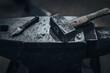 Heavy hammer with coinage on a rusty anvil