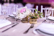 Wedding table red pink and white with tiny bouquet in a golden tiny pot