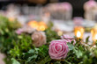 Closeup shot of a wedding pink rose decorating the couple table. 