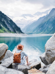 Wall Mural - Travel image. Traveler look on the mountain lake. Travel and active life concept. Adventure and travel in the mountains region in the Austria.