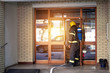 © luckybusiness - Fireman on the job.Fireman in uniform  at domestic fire in an apartment building.