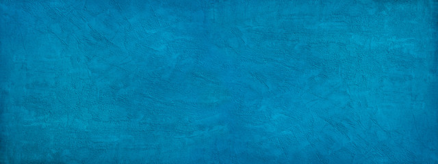 Wall Mural - Beautiful abstract blue background. Texture of decorative plaster on a concrete wall. Bright blue banner with a rough grainy plastered surface.