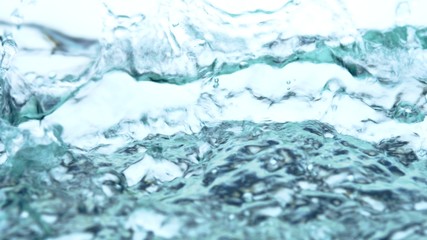 Soft blur focus of Abstract water splash surface filling the frame with the water drop and waving liquid with an air bubble on a white background and copy space.