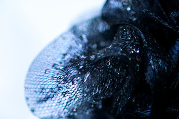 Background and backsplash of wet net with moist crystal water drops stuck between strings - abstract structure, technology, design navy blue macro