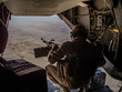 Helmand, Afghanistan - January 2013: Ramp gunner on a US MArines Osprey flying over Helmand
