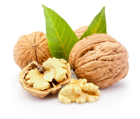 Wall Mural - Kernel and whole walnuts with leaves isolated on white background