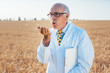 © Kzenon - Scientist in grain field testing the ears for quality