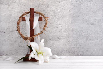 Wall Mural - Composition with crown of thorns, wooden cross and lily on light background
