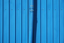 Close-up Of Blue Pipe And Metal Wall