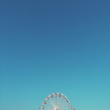 Ferris Wheel At Santa Monica Against Clear Blue Sky On Sunny Day