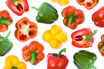 Wall Mural - Closeup fresh whole and half slice of green, red, yellow, orange bell peppers or capsicum isolated on white background. Top view. Flat lay.