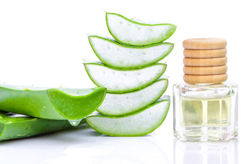 Wall Mural - Closeup bottle of aloe vera essential oil extract with aloevera leaf and cut slice isolated on white background. Skincare, health, beauty and spa concept.