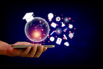 E-learning concept. Hand hold smartphone with  transparent earth and white education icon on blue technology background.