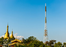 Telecom Signal Tower And Two Golden Pagodas With Warm Blue Sky In Mandalay Myanmar, New Technology Among Old History