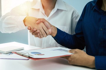 Wall Mural - Partnership. group business investor people partner handshake after finishing up business meeting with financial statistics report on desk in office, negotiation, investment and financial concept