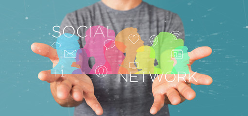 Poster - businessman holding a colorfull social network teamwork with icon 3d rendering