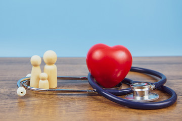  Family with stethoscope and a red heart. Concepts of a physical examination and health insurance.