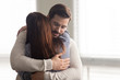 © fizkes - Handsome man embracing woman calms in difficult moment. Husband hugging wife relieves stress from work or health. Friends and couple relationship concept.