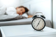 © joyfotoliakid - Close up Clock on the bed Asian woman wake up and disturbed by alarm clock early morning
