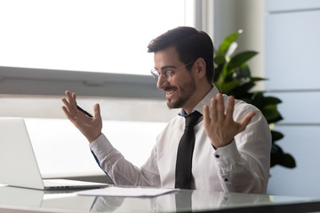 Wall Mural - Excited businessman celebrating business success achievement looking at laptop screen. Happy smiling employee feeling motivated by good work, get job or promotion, receive great news in email