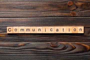 COMMUNICATION word written on wood block. COMMUNICATION text on wooden table for your desing, concept