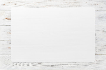 Top view of white table napkin on wooden background. Place mat with empty space for your design