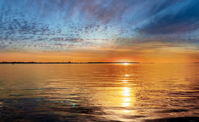 sunset at sea gold cloudy skyline and water wave reflection sunlight yellow blue nature landscape,gold sunset at sea cloudy skyline and water wave reflection sunlight yellow blue nature landscape