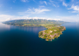 Sticker - Aerial: lake Toba and Samosir Island view from above Sumatra Indonesia. Huge volcanic caldera covered by water, traditional Batak villages, green rice paddies, equatorial forest.
