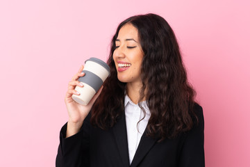 Wall Mural - Mixed race business woman holding coffee to take away over isolated pink background