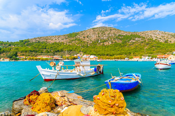 Colourful Greek fishing boats with nets on shore in Posidonio bay, Samos island, Greece