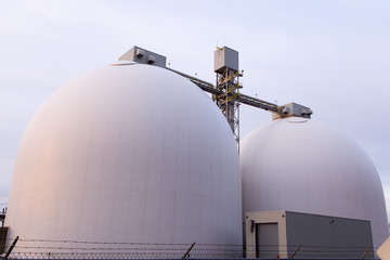 Two round toped white grain silos in the Foulon Cove port area seen from the Champlain Boulevard during sunrise, Quebec City, Quebec, Canada