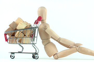 wooden mannequin and shopping cart, online shopping and delivery concept