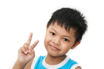 Portrait of an Asian smiling young boy showing two fingers, the sign 