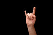 © ValeriyPH - hand raised up with fingers in the shape of devil symbol.