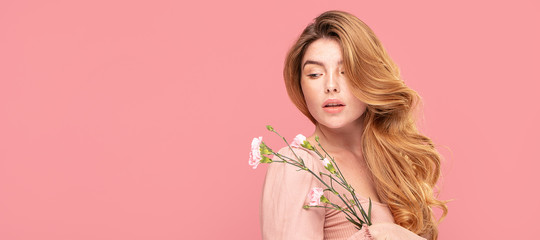 Natural young redhead woman with flowers.