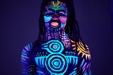 Portrait Of Calm Young African Male With UV Body Art, Muscular Man With Unusual Fantastic Prints On Naked Skin