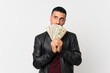 © luismolinero - Young man over isolated white background taking a lot of money